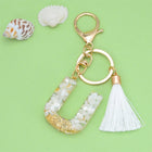 Llaveros Charms Personalizados con Iniciales - Letras Doradas y Borla Blanca para Bolsos