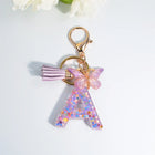 Llaveros Charms Letras A-Z con Colgante Mariposa y Borla - Accesorio Premium para Bolsos