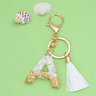 Llaveros Charms Personalizados con Iniciales - Letras Doradas y Borla Blanca para Bolsos