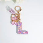 Llaveros Charms Letras A-Z con Colgante Mariposa y Borla - Accesorio Premium para Bolsos