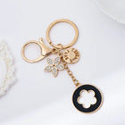 Bag Charm Premium de Trébol de 4 Hojas con Flor de Cristal - Llavero Elegante para Bolso