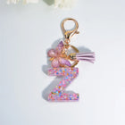 Llaveros Charms Letras A-Z con Colgante Mariposa y Borla - Accesorio Premium para Bolsos