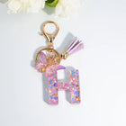 Llaveros Charms Letras A-Z con Colgante Mariposa y Borla - Accesorio Premium para Bolsos