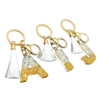 Llaveros Charms Personalizados con Iniciales - Letras Doradas y Borla Blanca para Bolsos